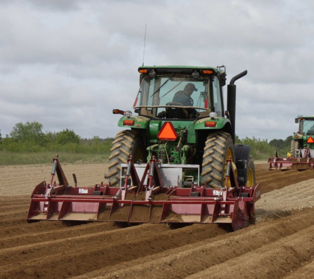 Spudnik's 4 Row Ridge Potato Hiller attached to a tractor.