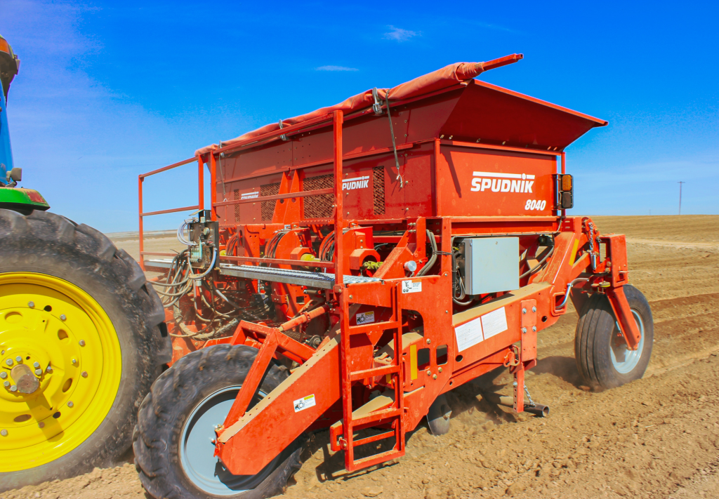 Spudnik's 4 Row Potato Planter being used in a farm.