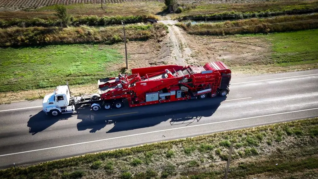 Spudnik's All-in-One Eliminator attached to a truck on the road being moved to a new location