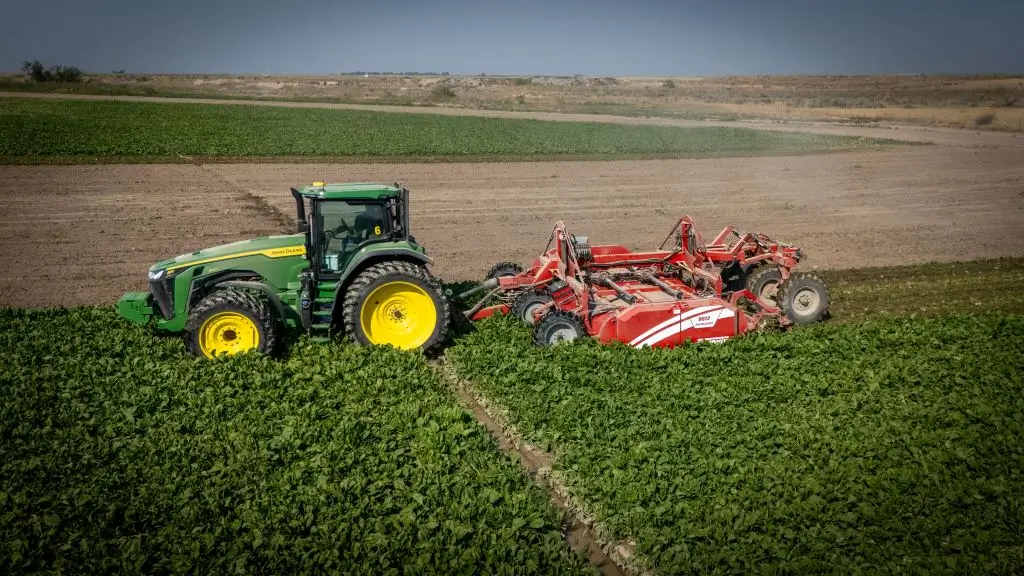 ASpudnik Defoliator attached to a John Deere Tractor in a sugar beets farm